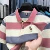 Striped Horse Logo Polo Shirt in pink, grey, and beige colors on a hanger.